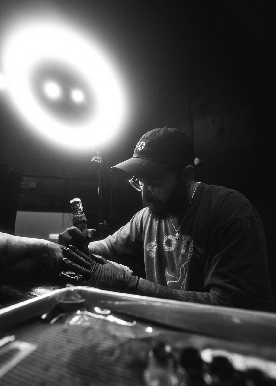 Robert Garcia tattooing under the ring light at The Lower Left
